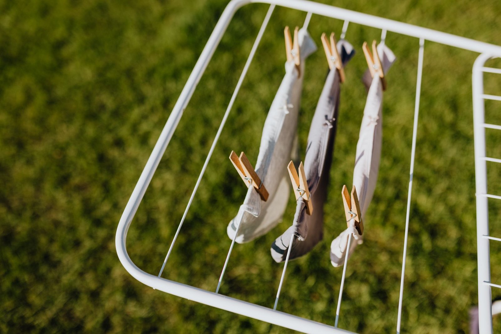 a pair of boxer briefs hanging on a drying rack, with a measuring tape showing the leg opening width