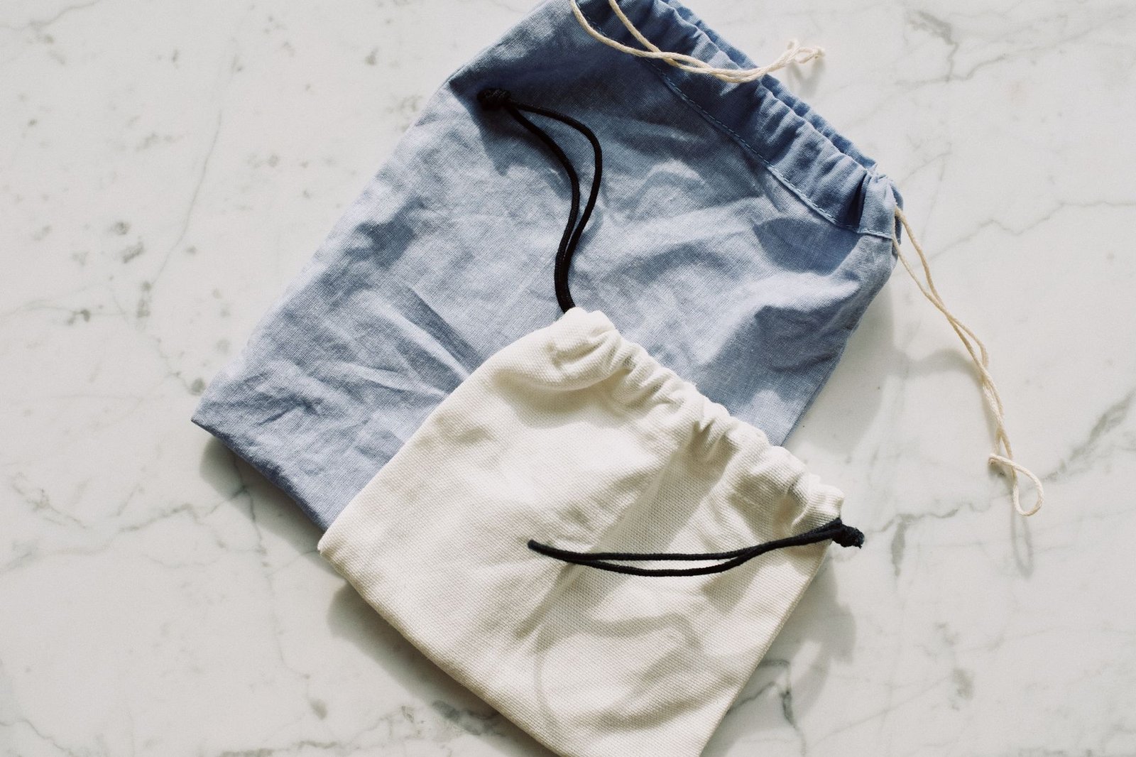 a split-screen of two pairs of underwear laid flat, one with a structured pouch and one with a smooth front, with a tailor's tape measuring inseam